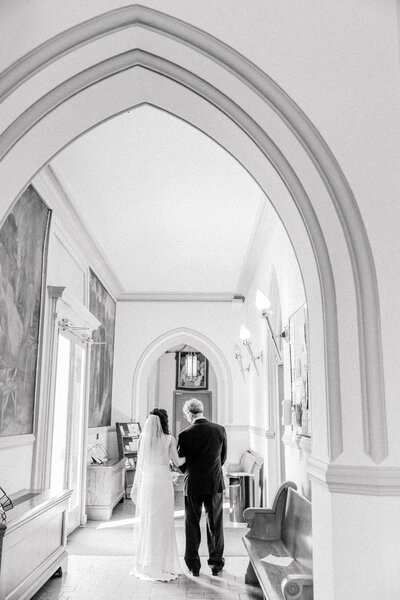 Father and daughter, arm in arm, enjoying their time together during the father, daughter first look