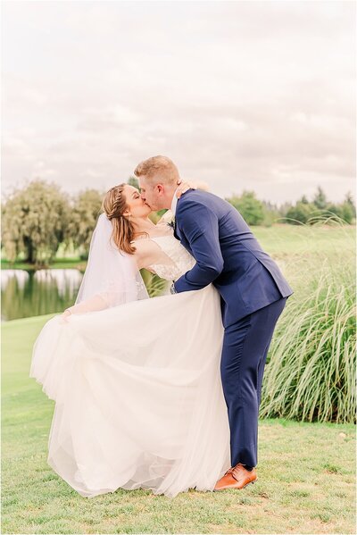 Bride and groom kissing at Langdon Farms Golf Club wedding photos