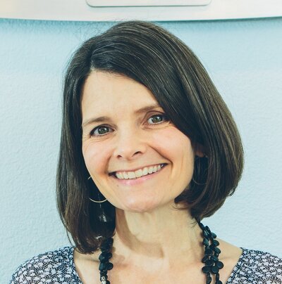 woman with dark brown hair smiling