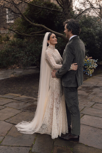 Wedding photographer captures couple taking a stroll hand in hand at their french chateau wedding.