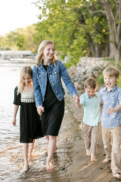 A white family walking on a sandy shoreline