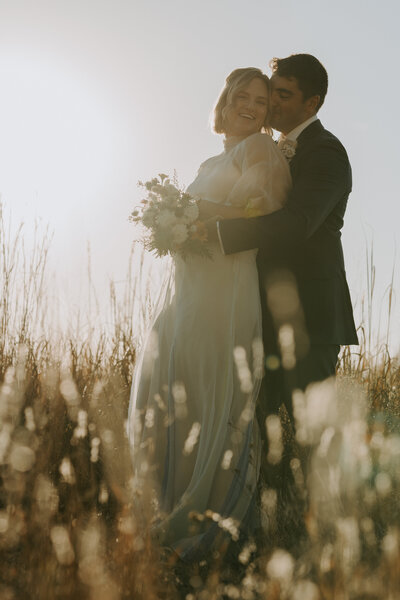 Bride & Groom in field, photographed by Wichita Wedding Photographer The Cantrells