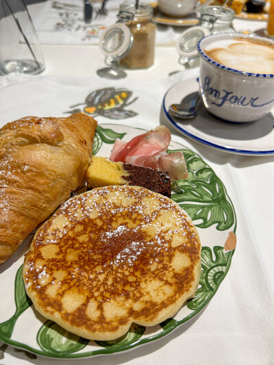 Pancakes, coffee, and croissant at Casa Gugu in Ravenna, Italy
