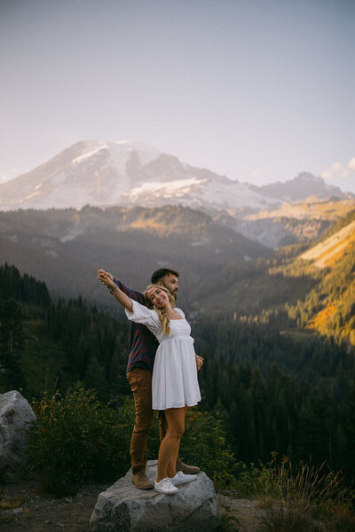 couple embracing at mt. rainier during sunset
