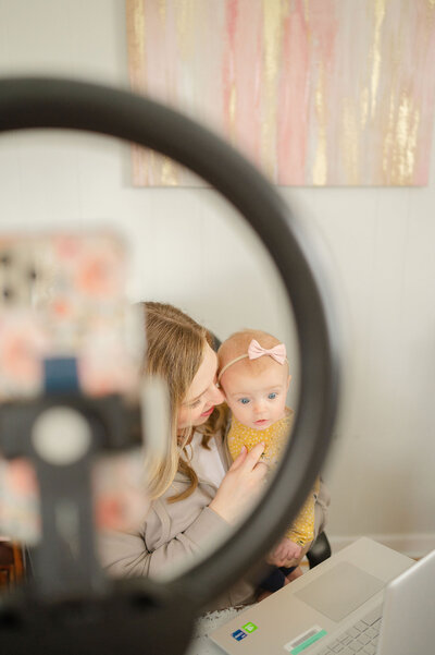 Erika with her daughter seen through a ring light
