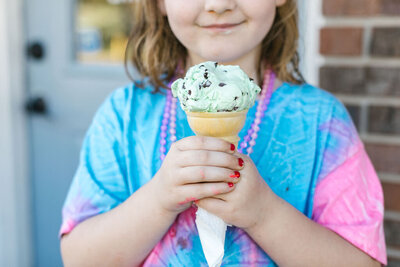 girl holding ice cram cone