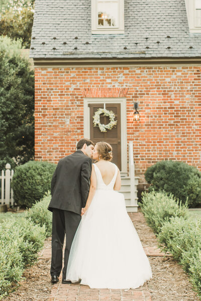 Wedding Photographer & Elopement Photographer, couple kissing in front of old cottage