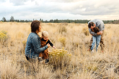 family with young children exploring open field