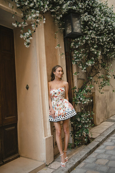 Bride and her bridesmaids walking through the village of Gordes, France in mismatched white lace dresses for a summer wedding