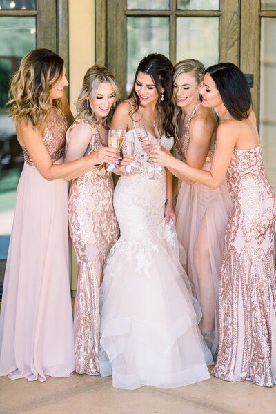 Bride with bridesmaids toasting glasses
