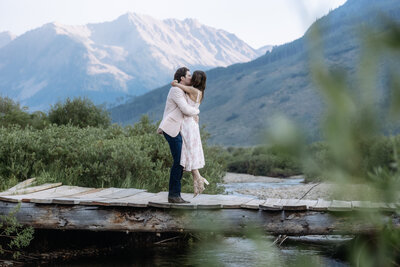 A cute couple hugging after getting engaged in Aspen, Colorado photo taken by Kelly Elizabeth Photography.