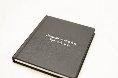 black leather wedding album with names and date engraved taken by spokane engagement photographer