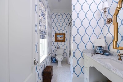 Traditional style bathroom featured blue and white wallpaper. 