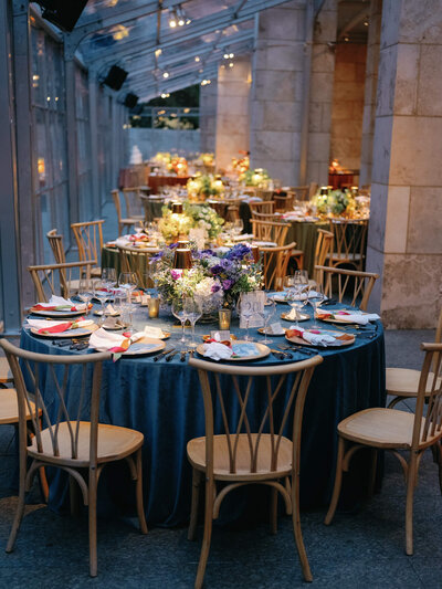 Ombre wedding reception with blue, sage and rust colored velvet linens
