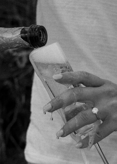 african american bride laughing in white wedding dress with hand over chest
