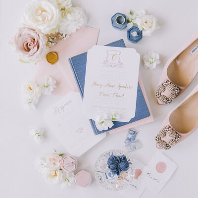 blush and gold foil floral crest monogram wedding invitation
