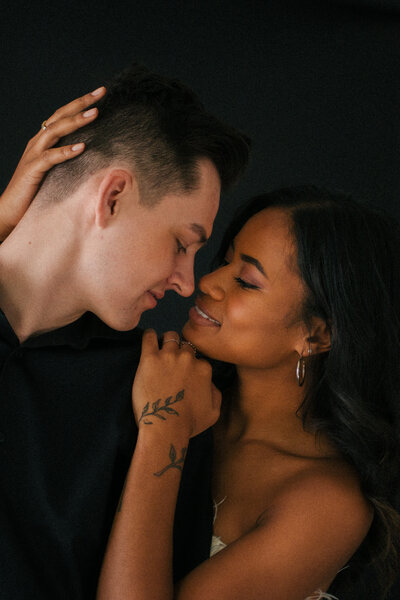 A tattooed couple laughing during their Springfield, MO elopement, captured by Chelsea Stanford