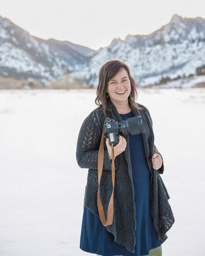 Stephanie, Denver wedding photographer smiles at the camera in a field of golden rod.