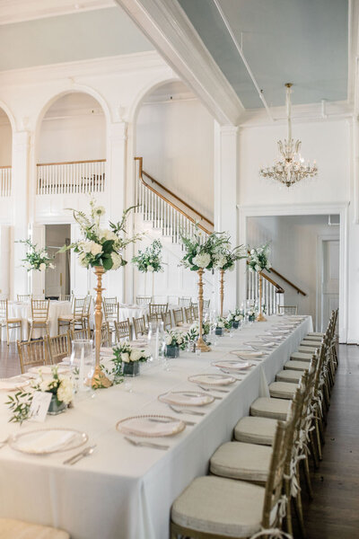 Classic wedding reception at Lexington Country Club with White tables, flowers on gold stands
