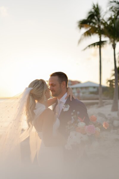 Couple kissing near palm trees