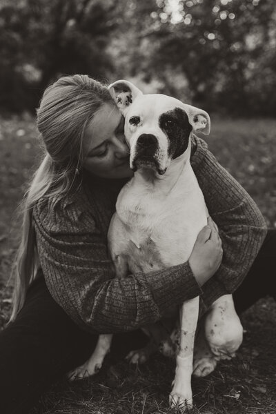 photo of woman hugging dog