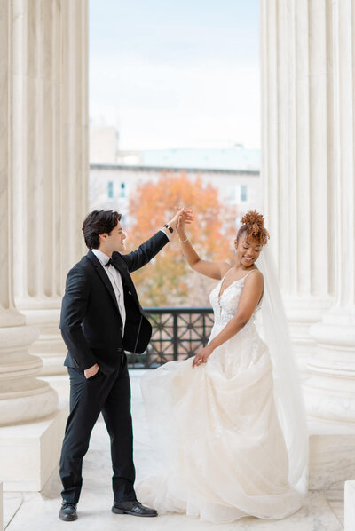 Bride and Groom twirling on the steps of the Supreme Court in Washington, DC. Taken by DC Wedding Photographer Bethany Aubre Photography.