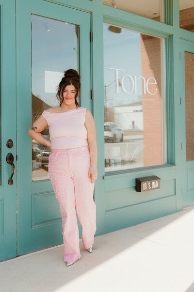 A stylist at Tone Salon shampoos a new client for a treatment service after her brunette balayage hair color service