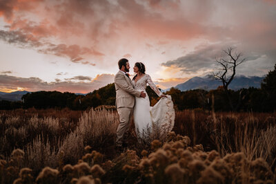 A couple in a field at sunset