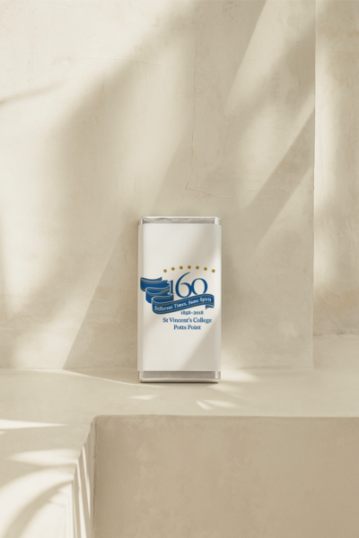 Luxury personalised chocolate bar in white and blue design celebrating St Vincent’s College Potts Point 160th anniversary, created by Barilliant for a commemorative event.