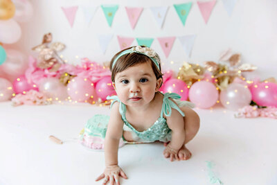 Little girl wearing a teal outfit for her Burlington, Ontario Cake Smash photography session.
