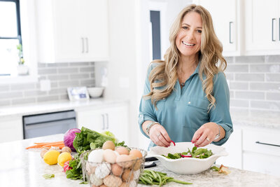 Amy in kitchen prepping a salad