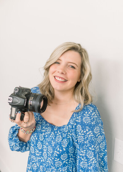 charleston photographer margaret Hicks standing in front of wall