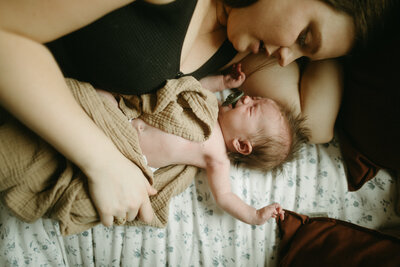 Mother during a newborn photoshoot in spokane wa.