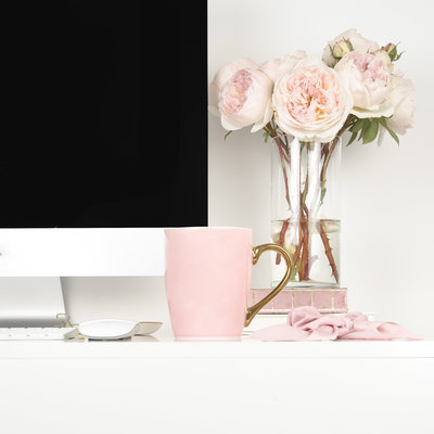 Pink flowers and coffee on table