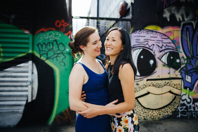 Queer Couple laughing in Wynwood during Engagement Photo Session
