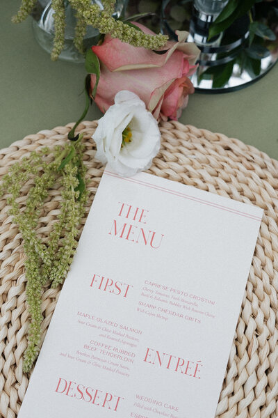 Menu and table florals of wedding tablescape coordinated by Wichita wedding planners Blush Events ICT.