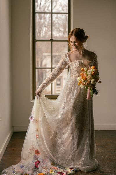 Stunning bride in a flowing white wedding gown captured at the church altar, holding a bouquet. Beautiful floral arrangements surround the bride, perfect for classic and elegant wedding photography.