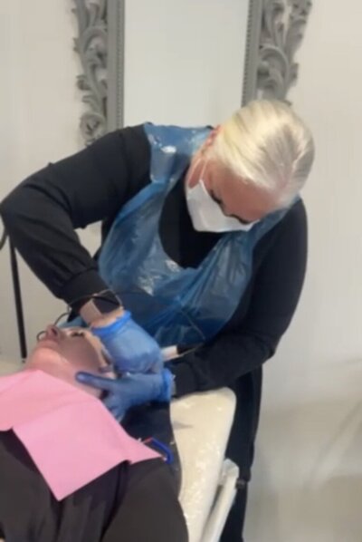 Mel using micro needling treatment on clients  face