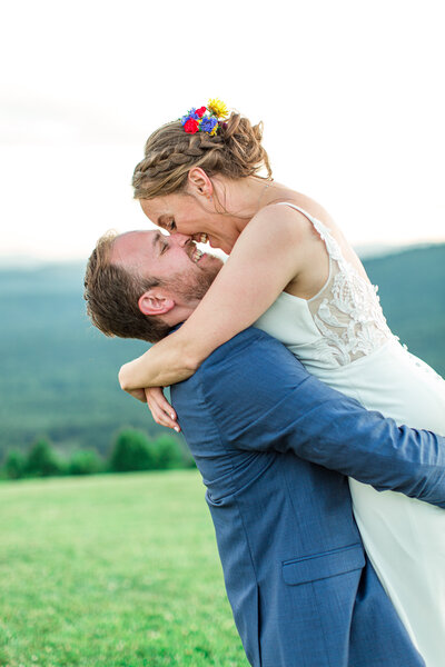 Wedding photo in Boone, NC of a groom picking up his bride on their wedding day.