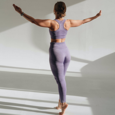 Women in purple performing yoga