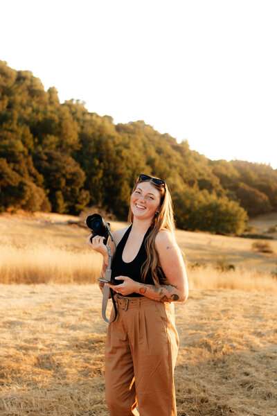 woman holding camera in the air