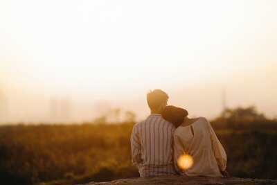 Couple sitting outside cuddling