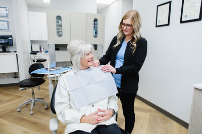 Prosthodontist recommending clear aligners as a discreet and effective teeth-straightening option to a patient at Peak Prosthodontics in Lethbridge, Alberta.