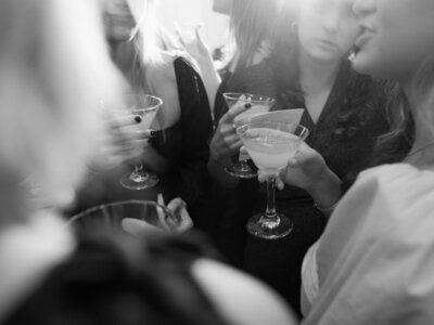 Black and white image hands holding drink glasses