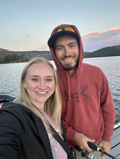 Jessica Nicole Photography posing together with her husband as they spend time fishing near Pinedale, Wyoming.