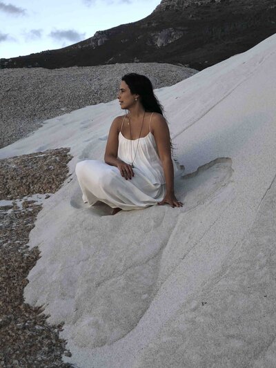 woman sitting on sand hill