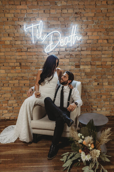 Downtown city elopement featuring 'til death neon sign by Stef Forward Events, trendy and modern decor rentals based in Calgary, AB. Featured on the Brontë Bride Blog.