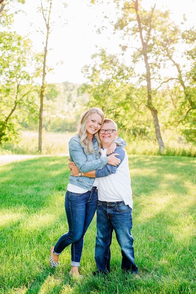 Brother and sister hugging in trees