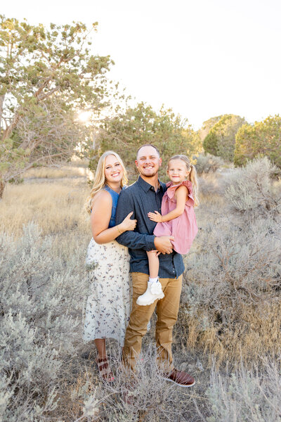 Cute young family portrait in the desert landscape of Eagle Mountain Utah