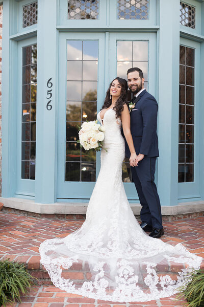 Gorgeous bride and groom by a colorful wedding venue in Jacksonville FL